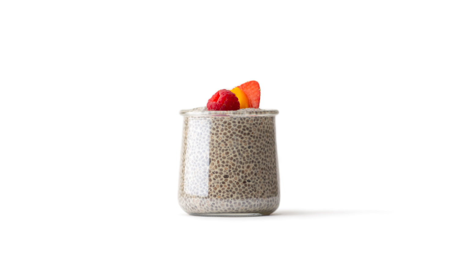 chia pudding a clear glass jar topped with a variety of fresh fruit