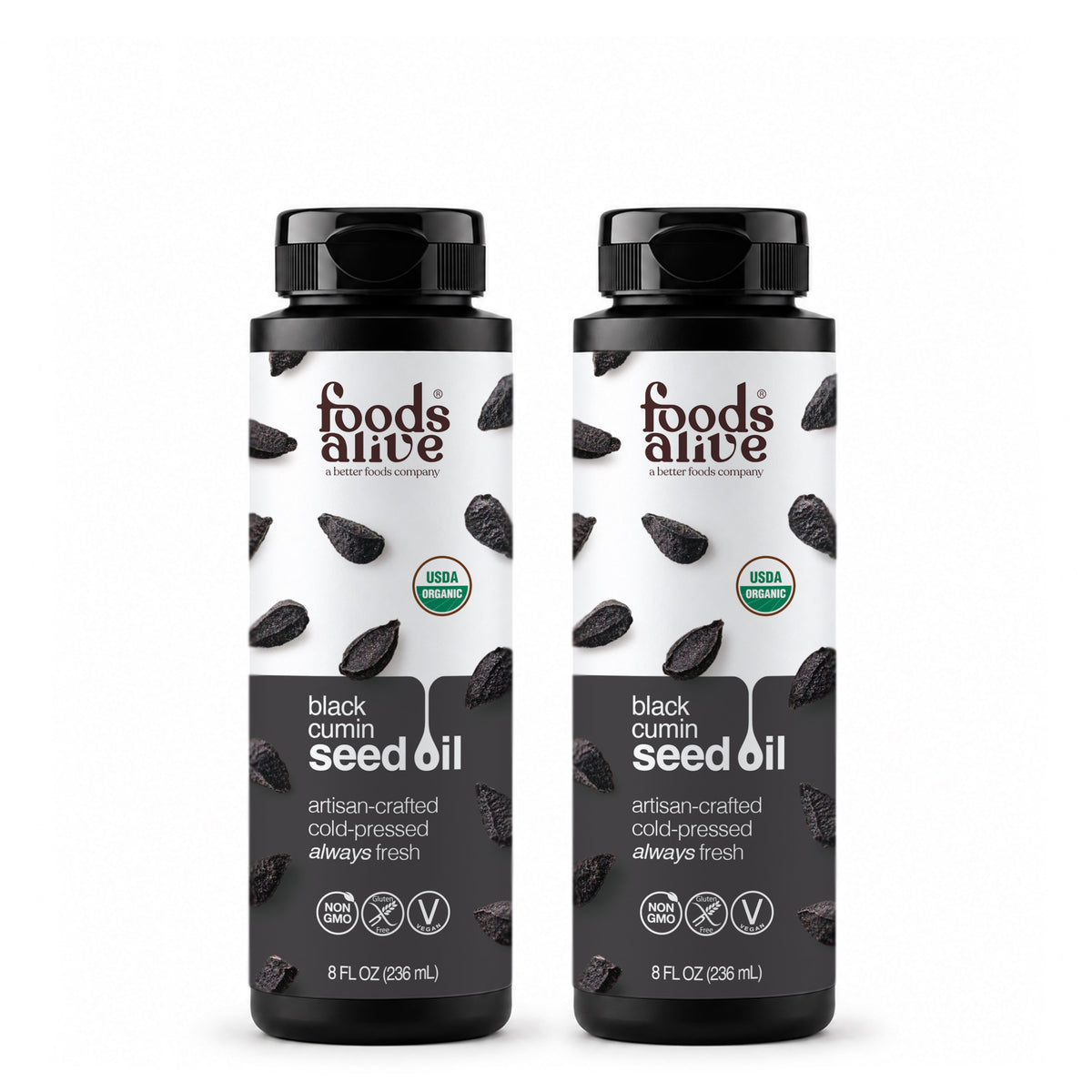 Two 8 oz black plastic bottles of Foods Alive Organic Black Cumin Seed Oil with white and charcoal labels featuring black cumin seeds. 