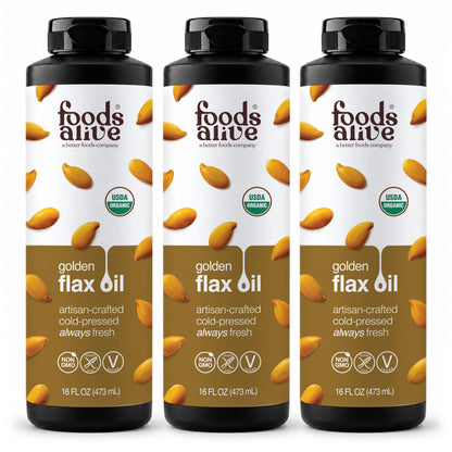Foods Alive Organic Cold-Pressed Golden Flax Oil 16 oz 3-pack, three black plastic bottles with black caps and gold labels featuring golden flaxseeds. 